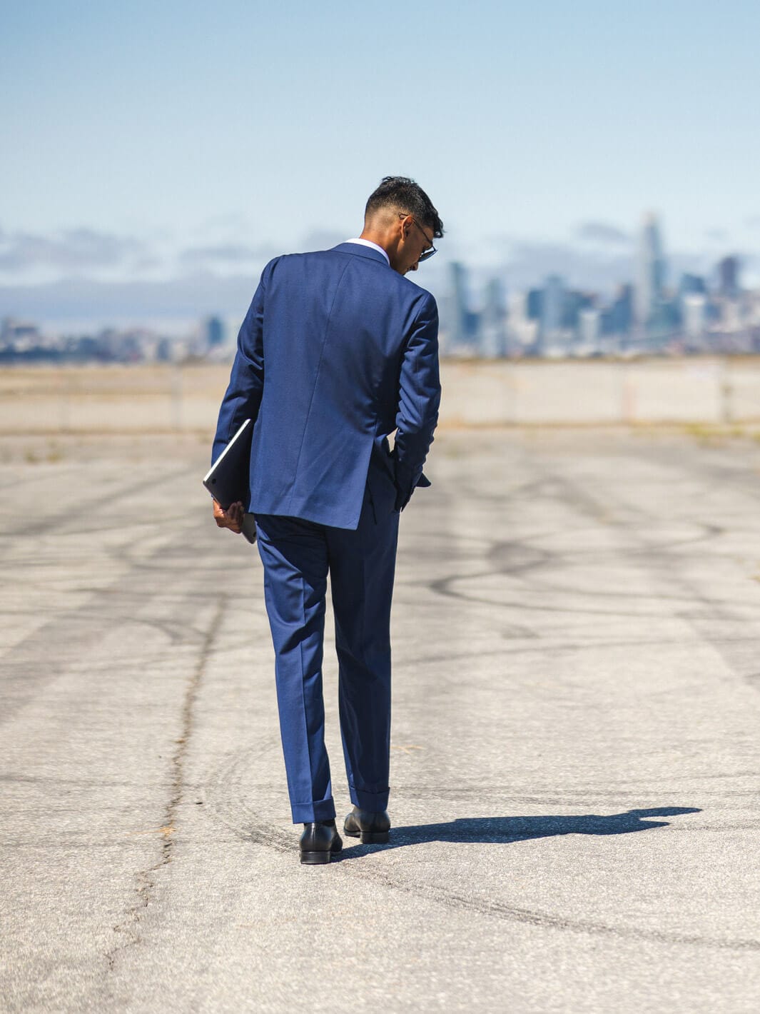 Man walks away with back of suit facing camera wearing Anatoly & Sons Blue Drago Skyfall Suit