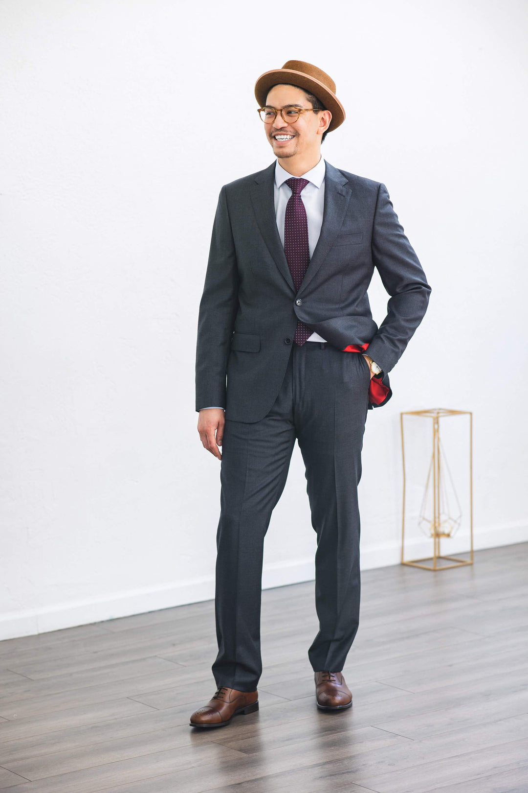 Full body shot of man smiling while wearing Anatoly & Sons Grey Drago Suit