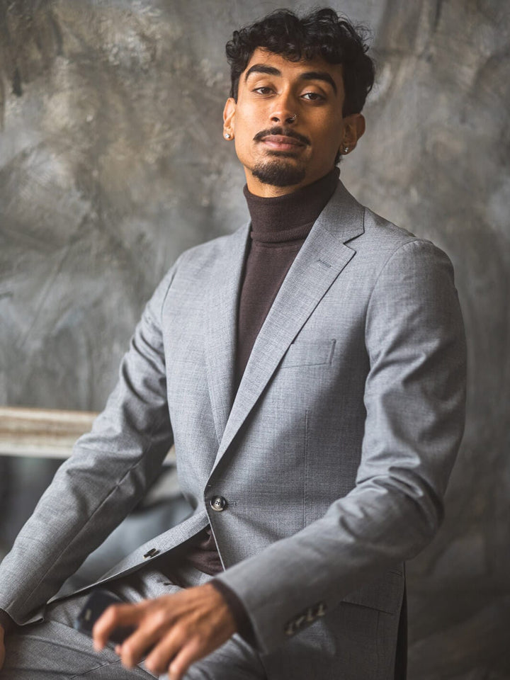 Man posing for camera wearing Anatoly & Sons Light Grey Skyfall Suit